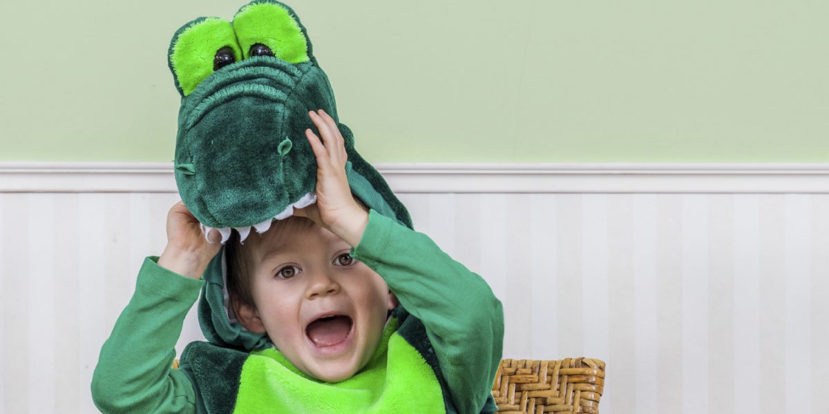 Adorable little boy in a crocodile suit